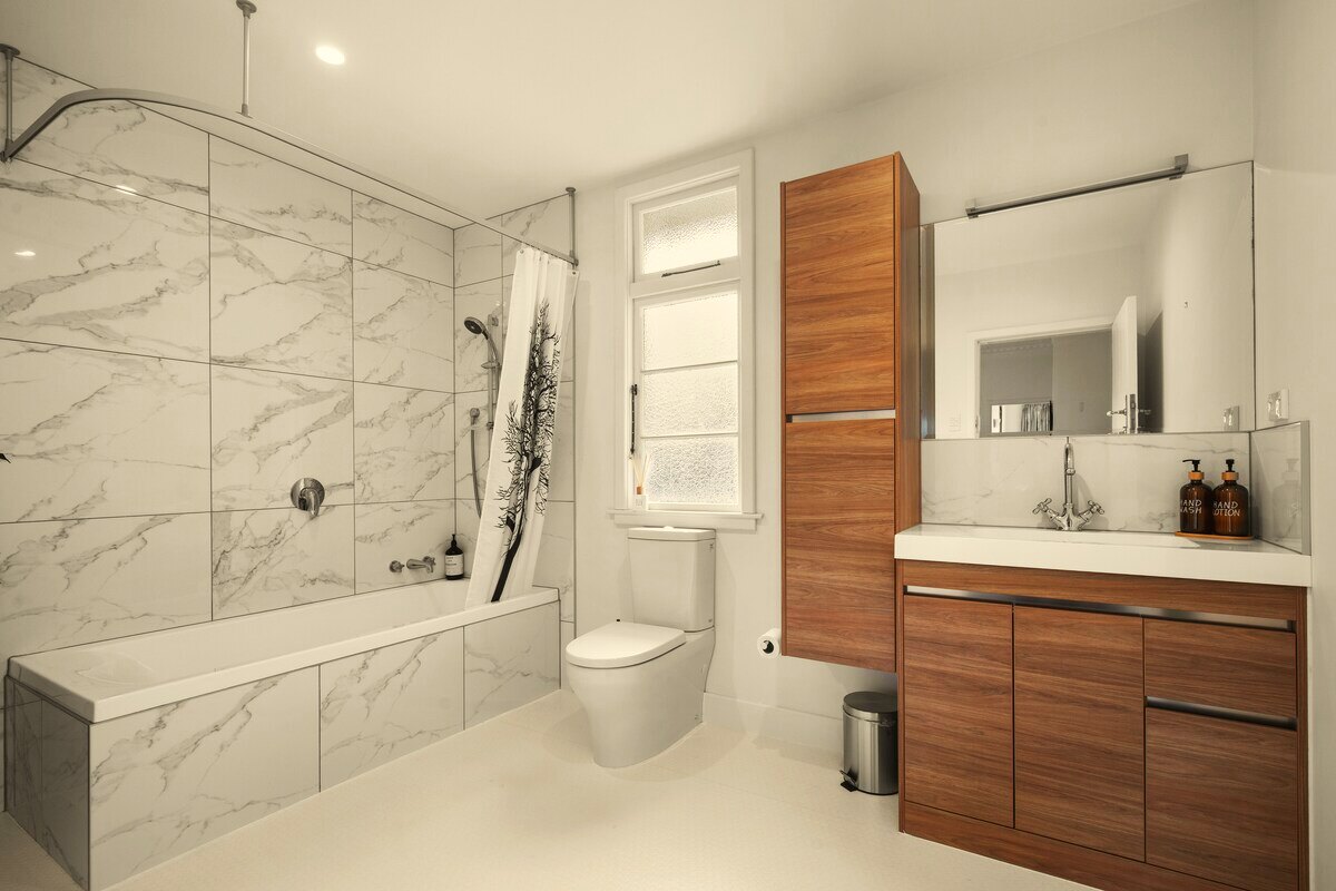 Main bathroom with tub and shower, walnut joinery
